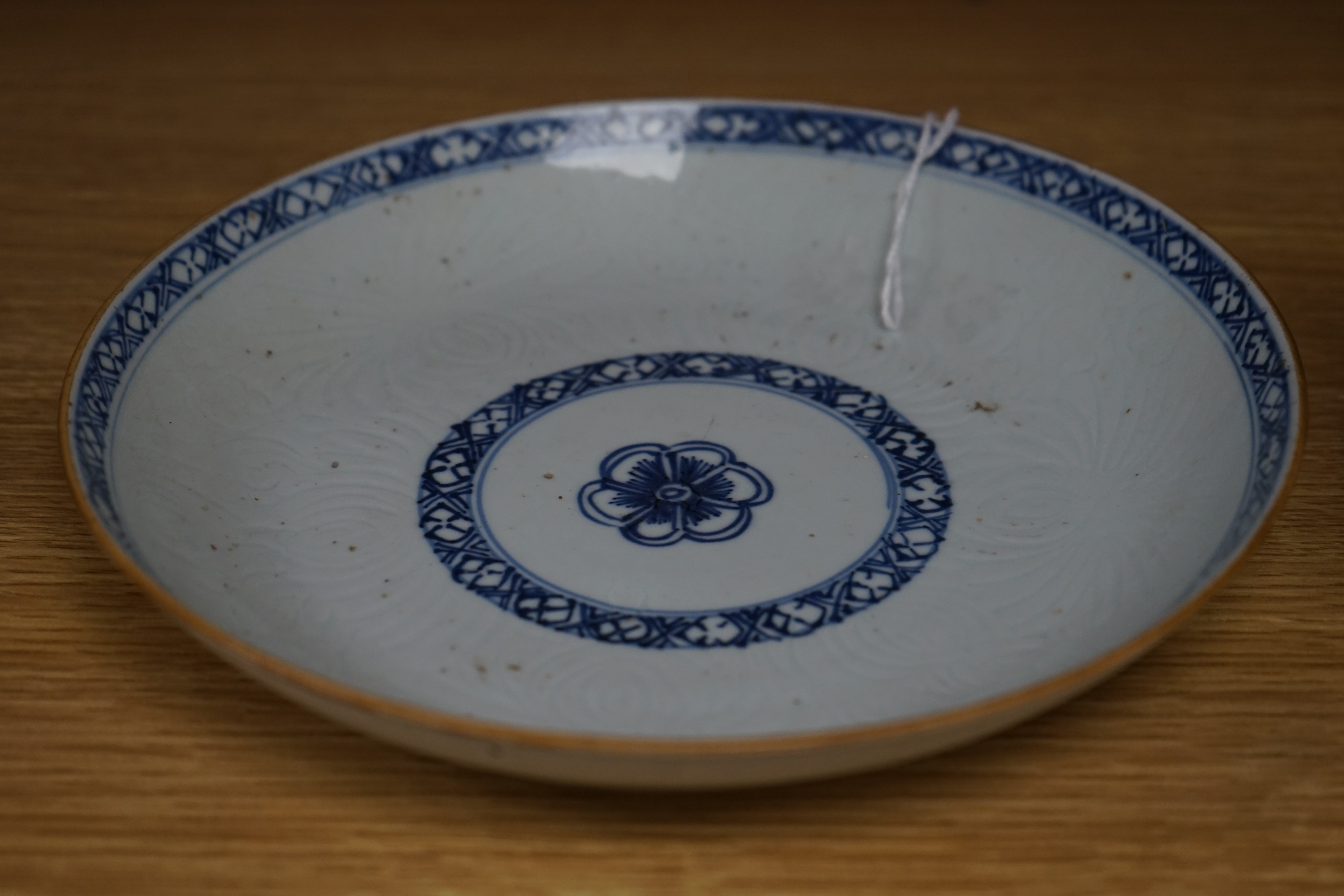 An 18th century Chinese shallow circular blue and white dish with incised decoration, Dia 22cm
